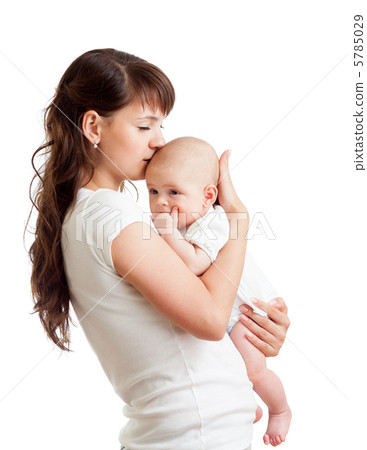 loving mother embracing and kissing her child isolated on white loving mother embracing and kissing her child isolated on white 5785029