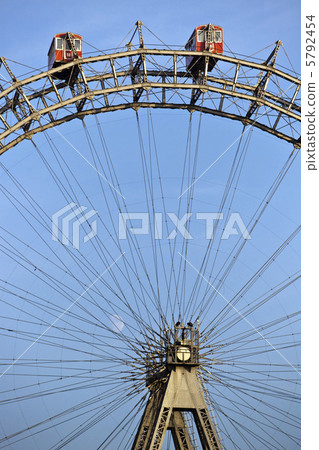 Sunlit ferris wheel of Vienna with little moon in the back 5792454