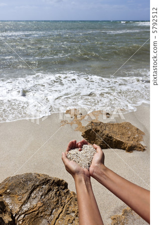 Mellow heart shaping female hands above beach Mellow heart shaping female hands above beach 5792512
