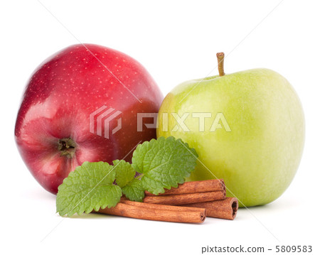 Red and green apples, cinnamon sticks and mint leaves still life 5809583