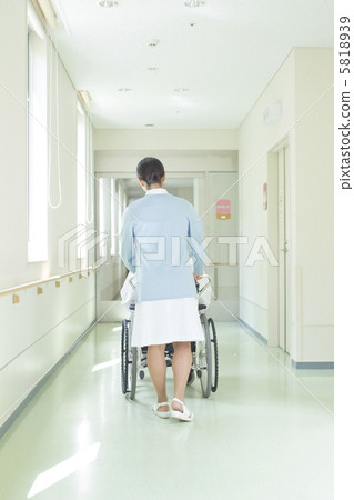 A nurse pushing a wheelchair 5818939