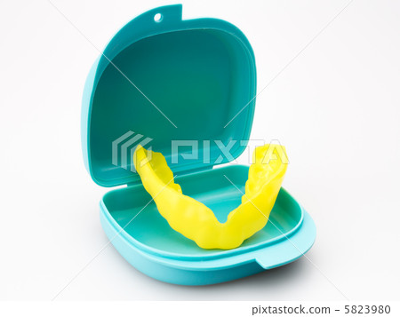 Yellow mouthpiece in blue case Background white Yellow mouthpiece in blue case Background white 5823980