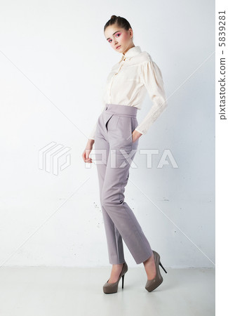 Lovely sensual girl in casual clothing standing in studio 5839281