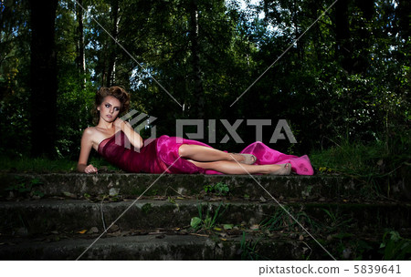 Evening scenic - pretty lady on staircase among nocturnal trees 5839641