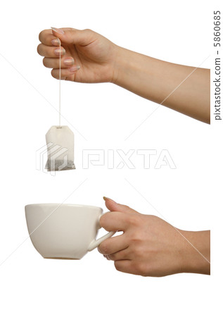 Hand holding teabag on white Hand holding teabag on white 5860685