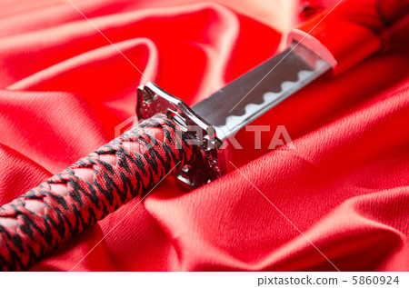 Japanese sword takana on red satin background Japanese sword takana on red satin background 5860924