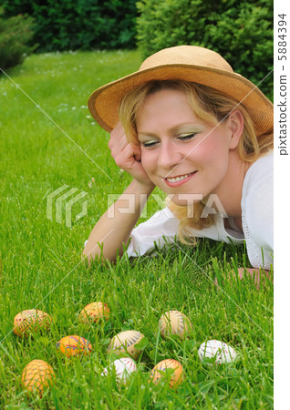 Young woman and easter eggs on the grass - Easter time Young woman and easter eggs on the grass - Easter time 5884394