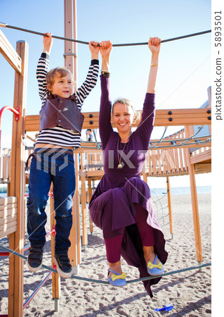 Mother and son playing at playground. Mother and son playing at playground. 5893501