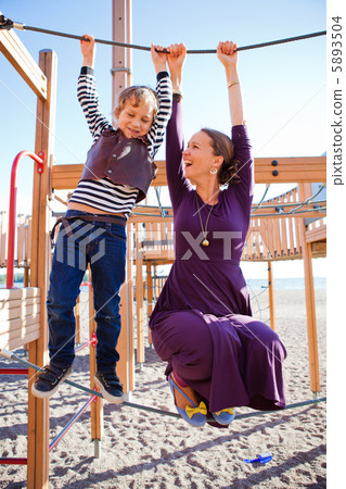 Mother and son playing at playground. 5893504