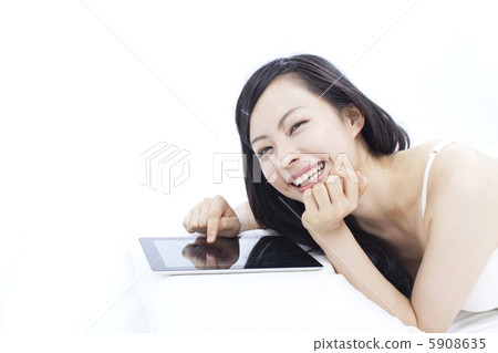A woman using a tablet PC A woman using a tablet PC 5908635
