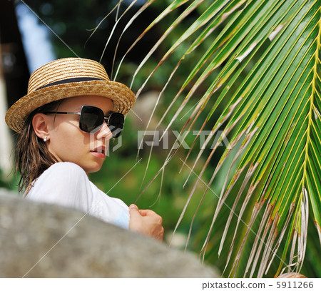 Woman in sunglasses near palm tree Woman in sunglasses near palm tree 5911266
