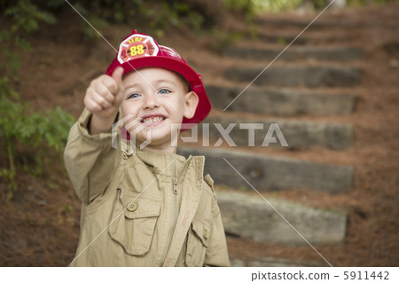 Adorable Child Boy with Fireman Hat Playing Outside 5911442