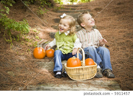 Brother and Sister Children Sitting on Wood Steps with Pumpkins Brother and Sister Children Sitting on Wood Steps with Pumpkins 5911457