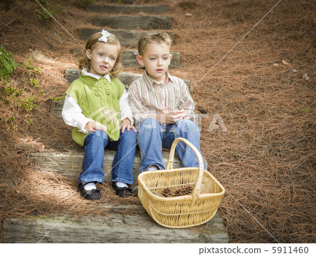 Two Children on Wood Steps with Basket of Pine Cones Two Children on Wood Steps with Basket of Pine Cones 5911460