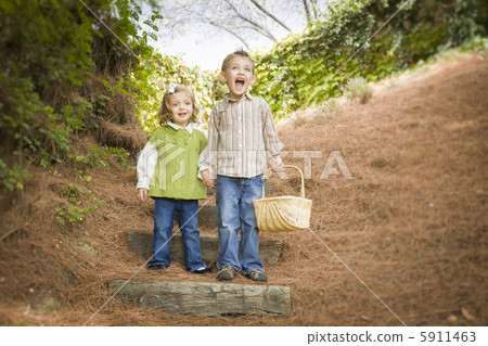 Two Children Walking Down Wood Steps with Basket Outside. Two Children Walking Down Wood Steps with Basket Outside. 5911463