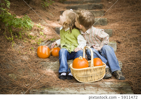 Brother and Sister Children on Wood Steps with Pumpkins Playing Brother and Sister Children on Wood Steps with Pumpkins Playing 5911472