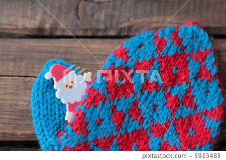 Santa Claus peeking out from a hand-knitted glove Hand-knitted knit 5913485