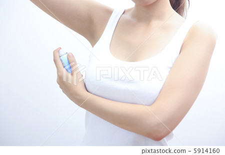 A woman spraying a deodorant antiperspirant A woman spraying a deodorant antiperspirant 5914160