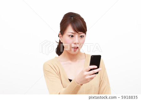 A woman surprised at a smartphone 5918835