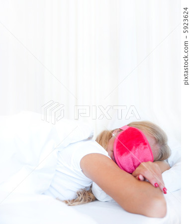Closeup portrait of a cute young woman sleeping on the bed weari Closeup portrait of a cute young woman sleeping on the bed weari 5923624