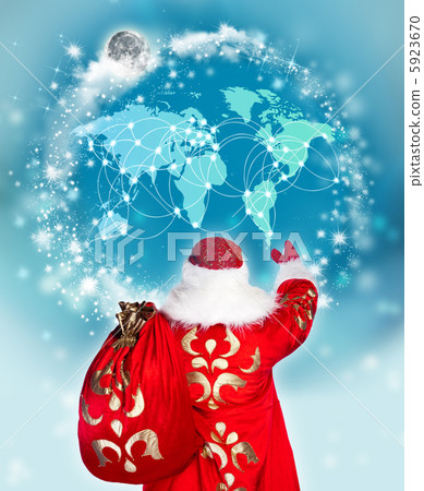 Santa Claus preparing for Christmas. He is looking at digital wo 5923670