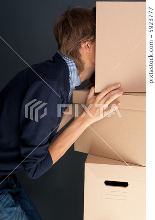 Portrait of anonymous young man with his head inside box 5923777