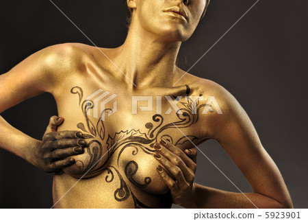 Portrait of young sexy woman in golden paint 5923901