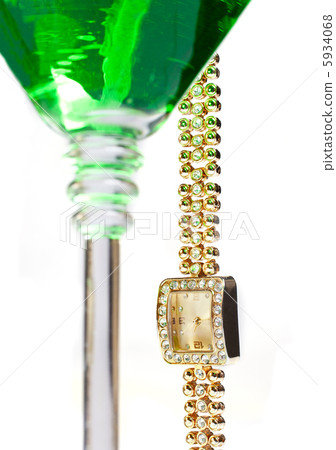 wrist watch hanging from martini glass 5934068