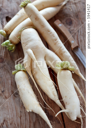 Daikon radish on the wood background Daikon radish on the wood background 5941417