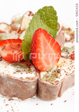 Tiramisu Sushi Roll garnished with Strawberry and Mint Tiramisu Sushi Roll garnished with Strawberry and Mint 5941419
