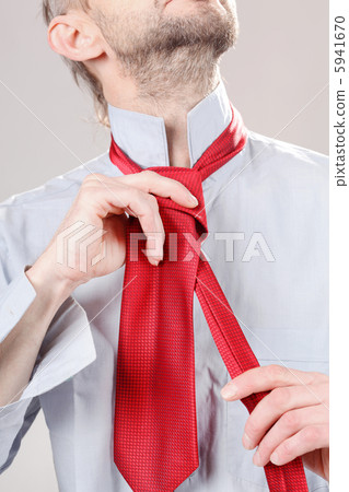Man adjusting tie 5941670