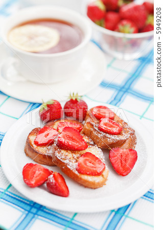 French toasts with powdered sugar and a strawberry 5949208