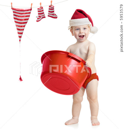 Happy kid in Santa's hat washing his accessories Happy kid in Santa's hat washing his accessories 5953579