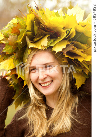 Woman with autumn wreath outdoors Woman with autumn wreath outdoors 5954958