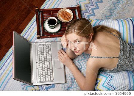 Girl with laptop and coffee in the bed 5954960