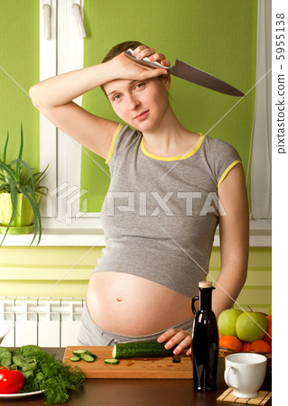 pregnant woman on kitchen with knife pregnant woman on kitchen with knife 5955138
