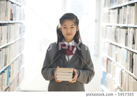 Junior high school students with books in the library 5957385