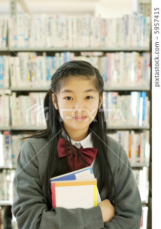 Junior high school students standing in front of the bookshelf 5957415
