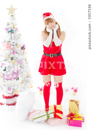 A cute Santa girl surrounded by many gifts next to the Christmas tree A cute Santa girl surrounded by many gifts next to the Christmas tree 5957586