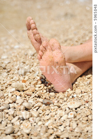 Relaxation on beach, detail of male feet 5965848