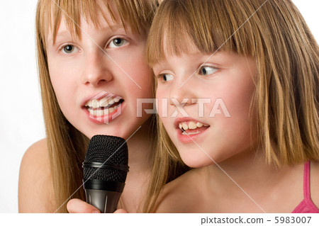 Two little sisters singing in microphone Two little sisters singing in microphone 5983007