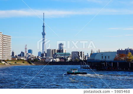Tugboat and Tokyo Sky Tree sailing the Sumida river spreading blue sky to the downstream 5985468