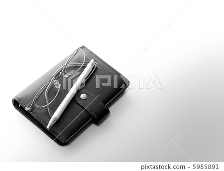 Glasses and a pen placed in a black notebook Glasses and a pen placed in a black notebook 5985891