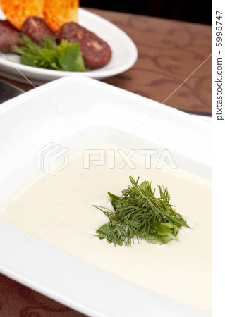 cream soup with potato chips and black pudding cream soup with potato chips and black pudding 5998747