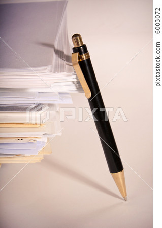 a pen near stack of paper a pen near stack of paper 6003072