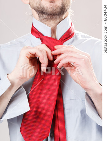 Man adjusting tie 6004434