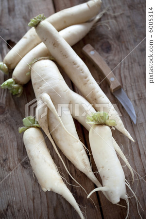 Daikon radish on the wood background Daikon radish on the wood background 6005314