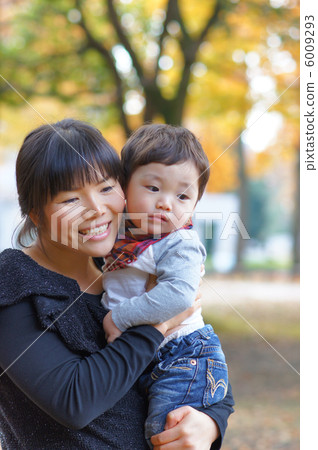Mom and one year old child in autumn park Mom and one year old child in autumn park 6009293