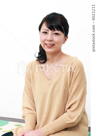 A woman sitting on a carpet A woman sitting on a carpet 6021211