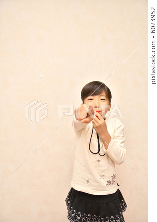 A girl playing a whistle A girl playing a whistle 6023952